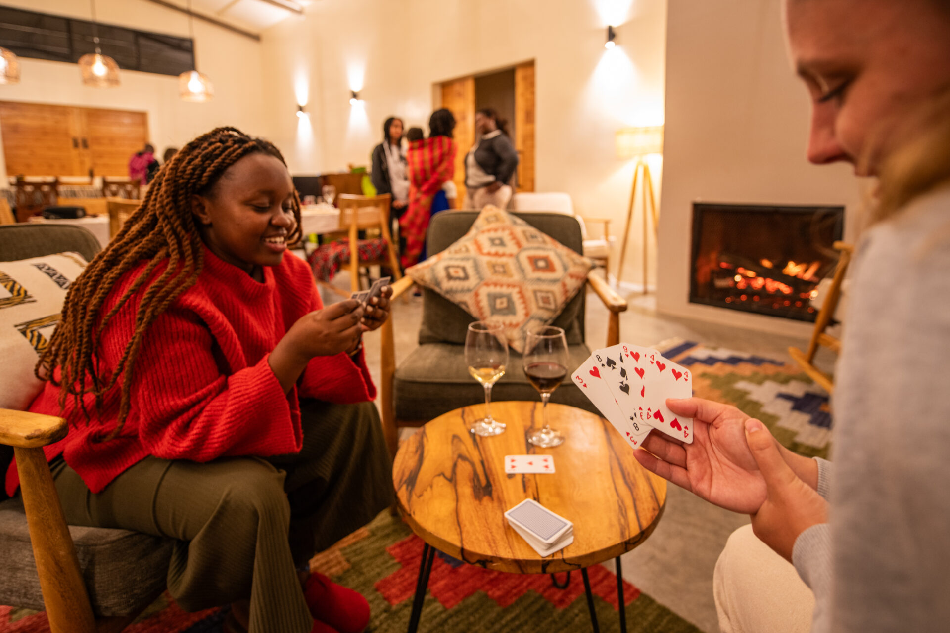 Guest enjoying a game of board or card activity indoors at lodge.
